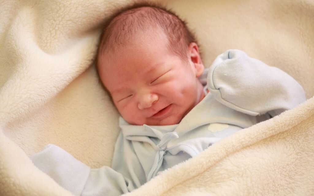 why do babies smile in their sleep