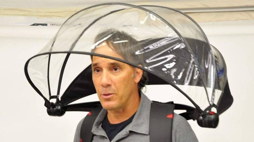 Alan Kaufman wearing the Nubrella hands-free umbrella invention, showcasing the innovative transparent design that appeared on Shark Tank.